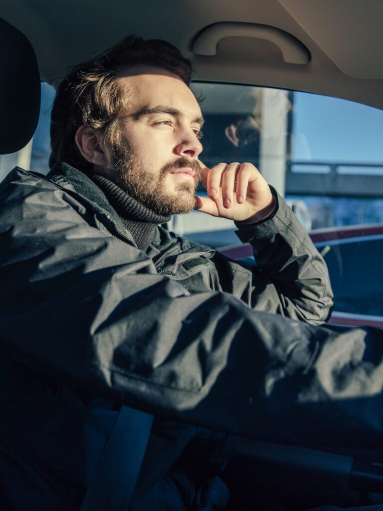 man driving a car with sun shining on his face 2024 09 18 17 53 36 utc